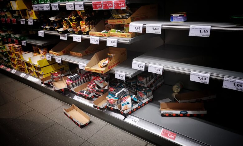 Rows of packaged food products on supermarket shelves representing large consumer brand portfolios
