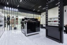 Interior of a high-end luxury fashion boutique with minimalist display cases