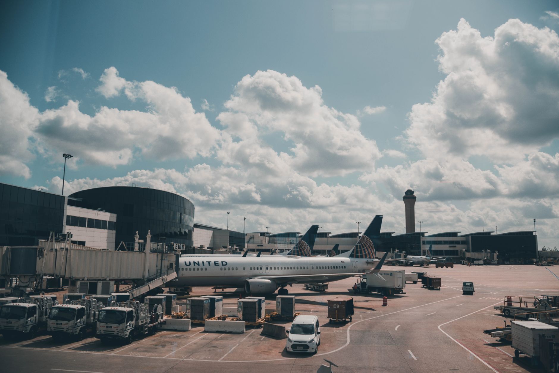 Commercial aircraft parked on airport tarmac awaiting delivery