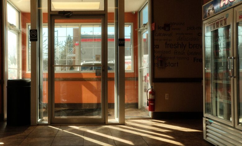 Interior of a modern convenience store with illuminated shelves and packaged goods