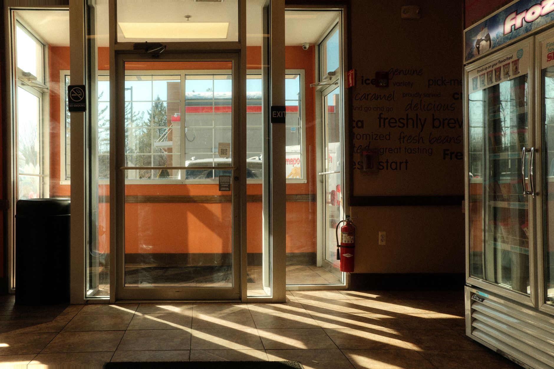 Interior of a modern convenience store with illuminated shelves and packaged goods