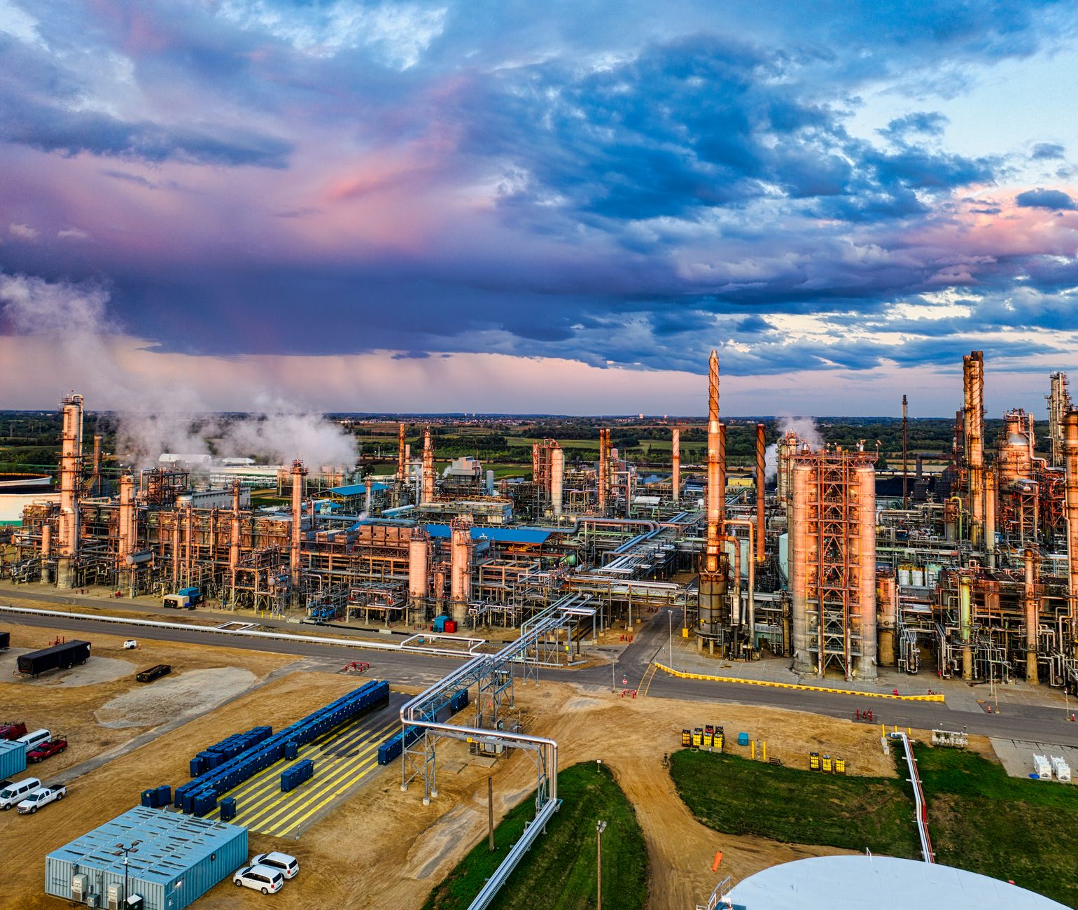 Aerial view of a large oil refinery with processing towers and pipelines