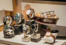 A collection of luxury Swiss watches displayed on a retail counter