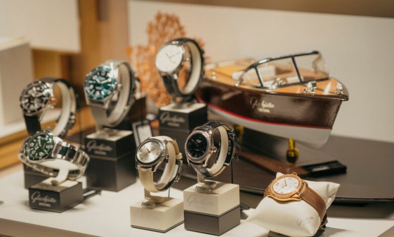 A collection of luxury Swiss watches displayed on a retail counter