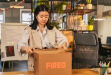 Employee clearing desk in a corporate office during a layoff