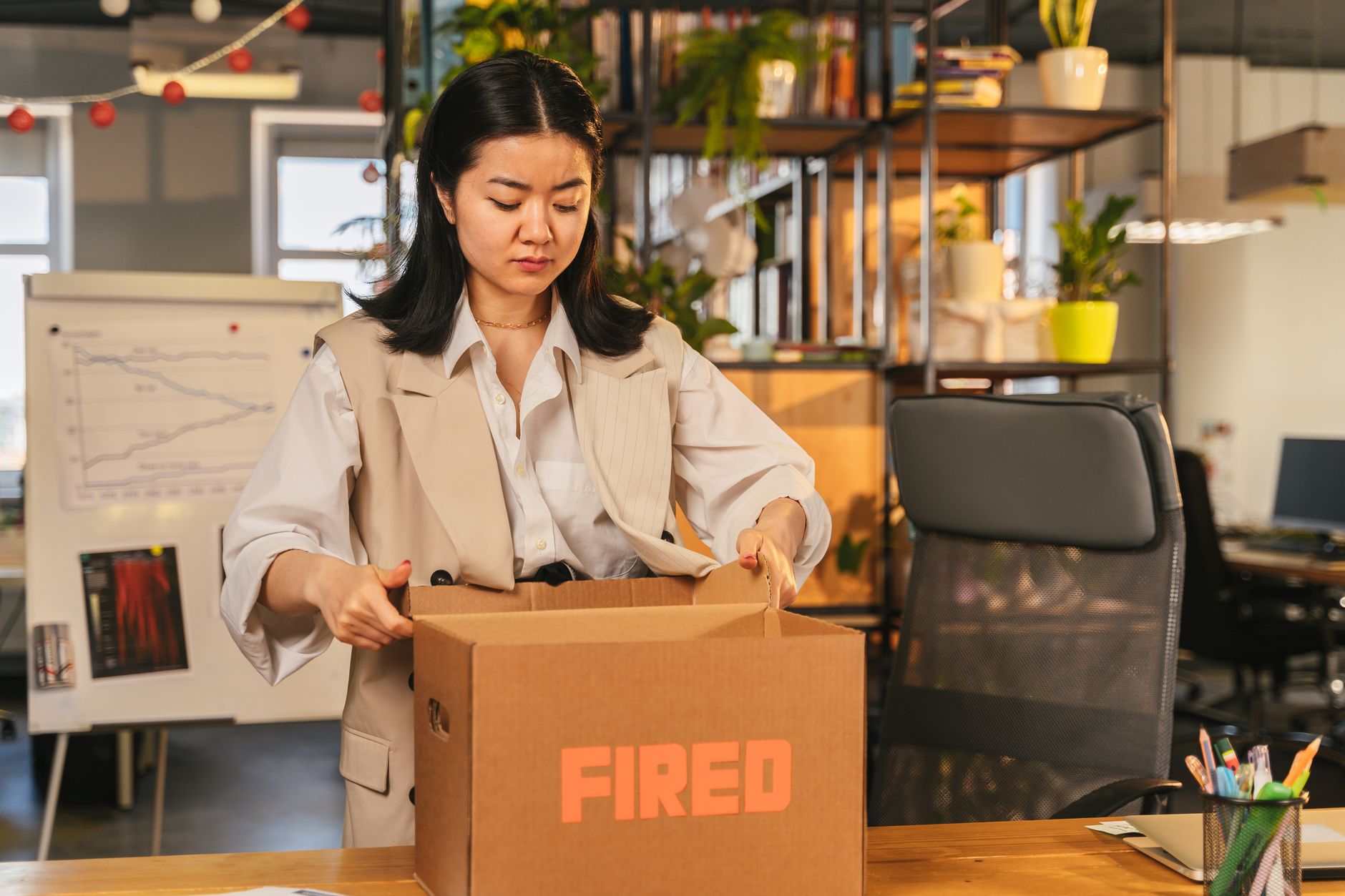 Employee clearing desk in a corporate office during a layoff