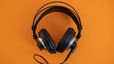 Person wearing headphones listening to audio content on a smartphone