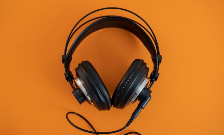 Person wearing headphones listening to audio content on a smartphone