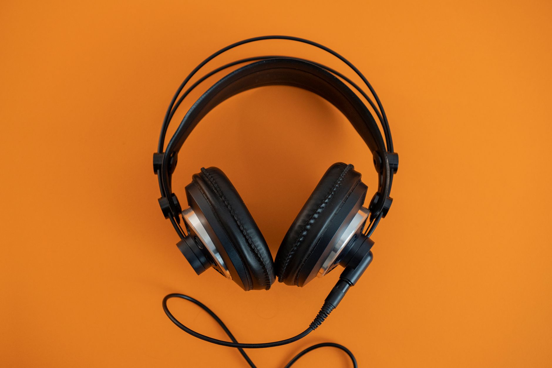 Person wearing headphones listening to audio content on a smartphone