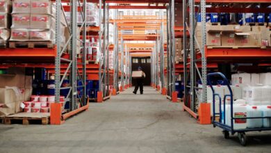 Workers sorting packages inside a large warehouse fulfillment center