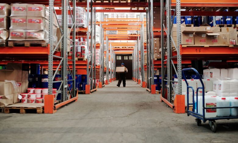Workers sorting packages inside a large warehouse fulfillment center