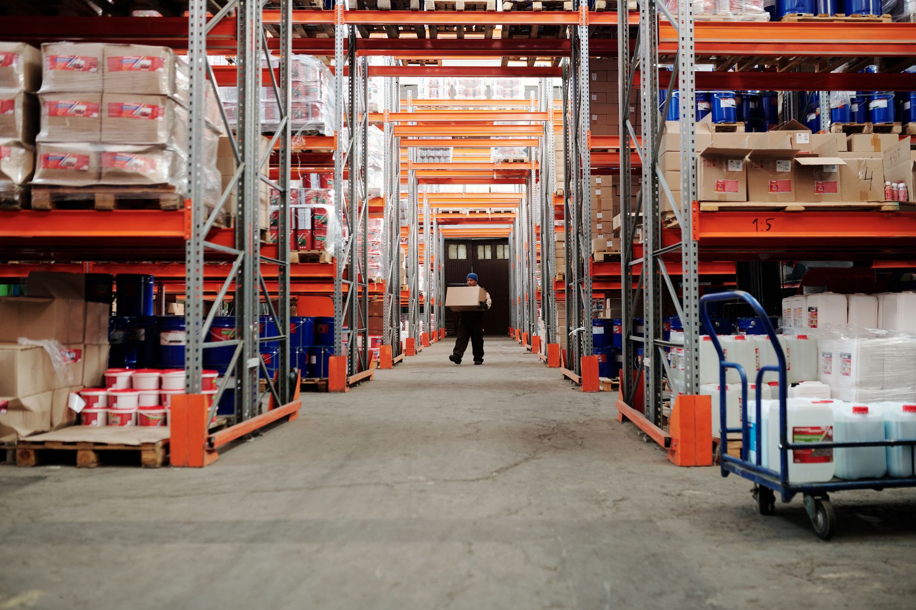 Workers sorting packages inside a large warehouse fulfillment center