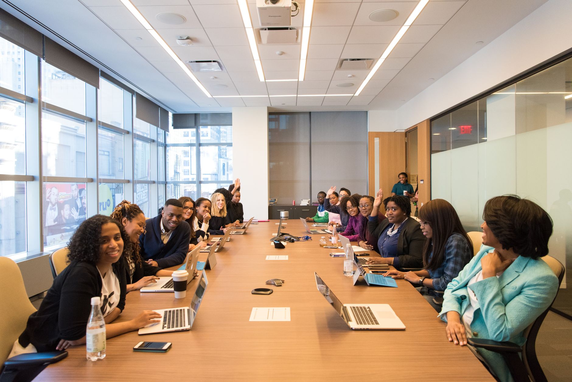 Business professionals meeting around a table in a technology company office