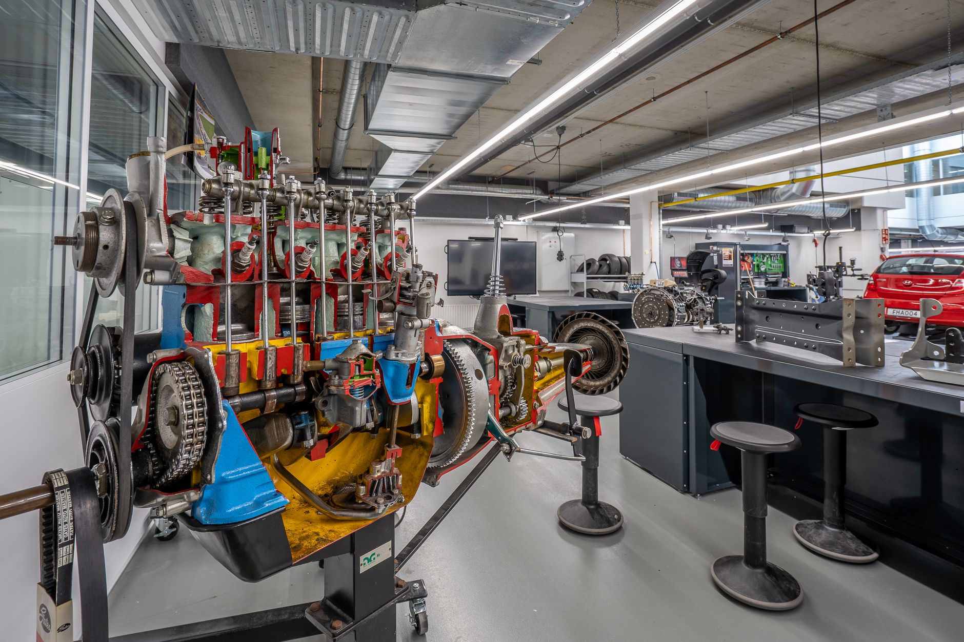 Engineers collaborating around technical blueprints in an automotive development setting