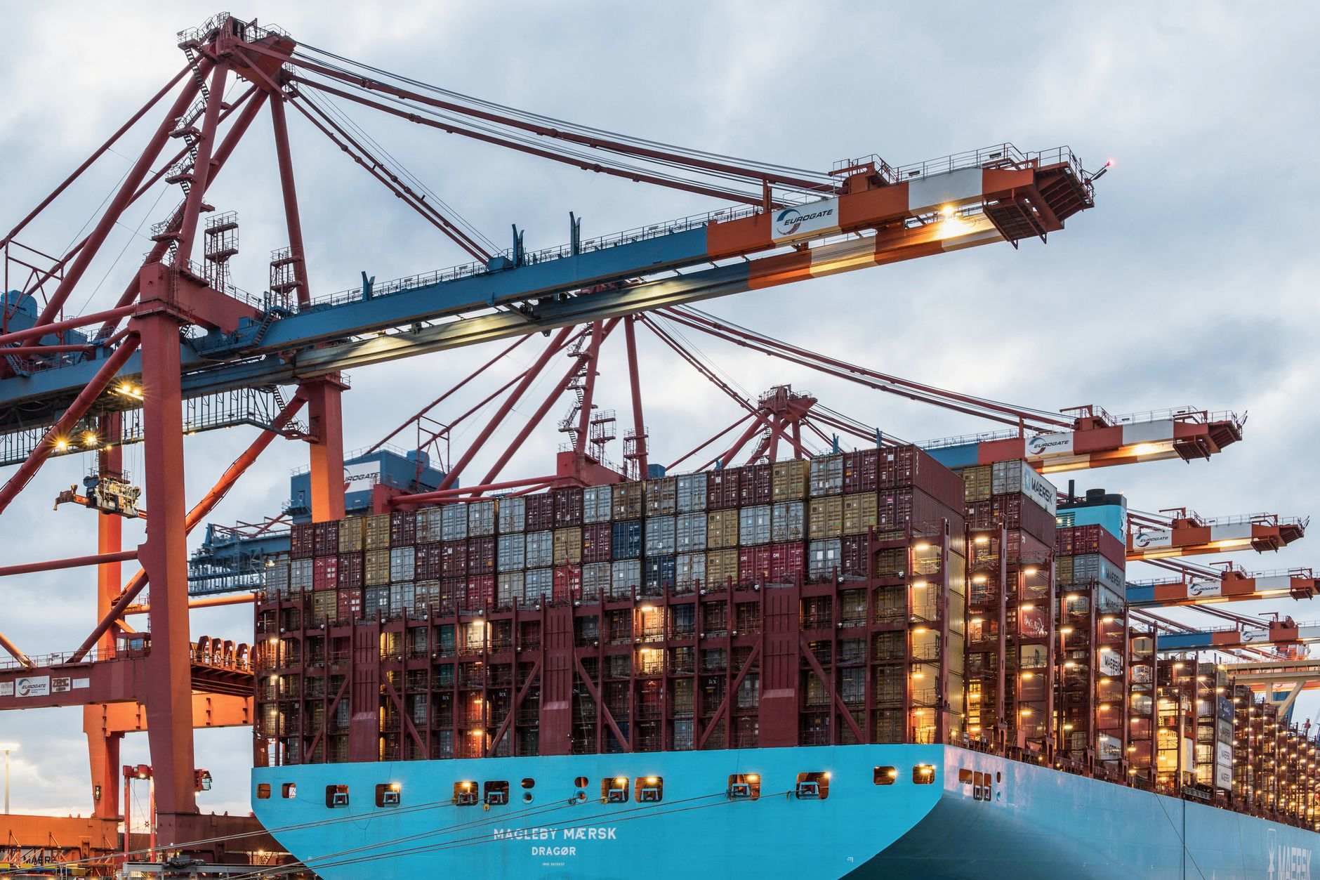 Large cargo containers stacked at a busy international shipping port