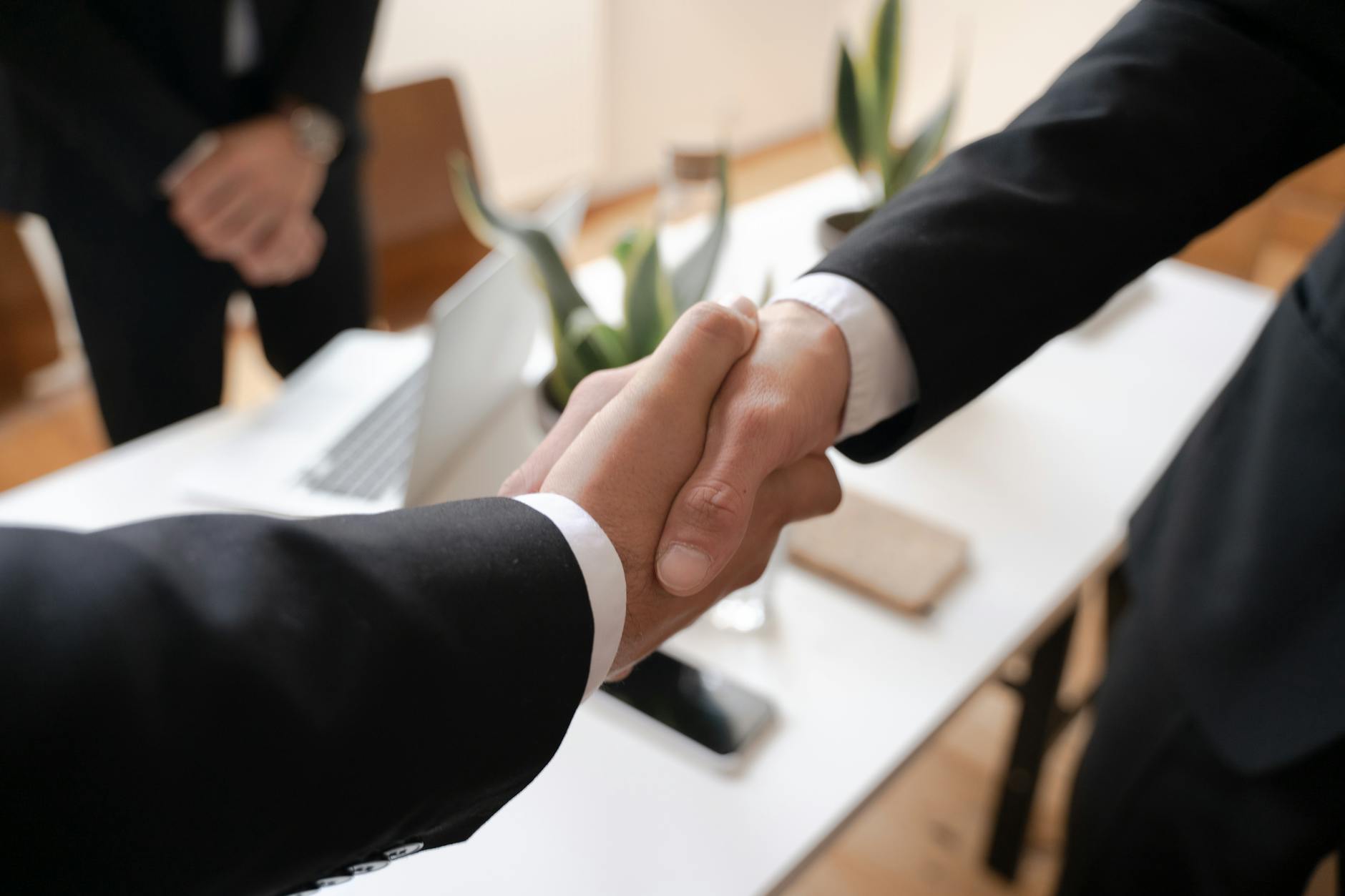 Two people reviewing documents at a table during a business negotiation