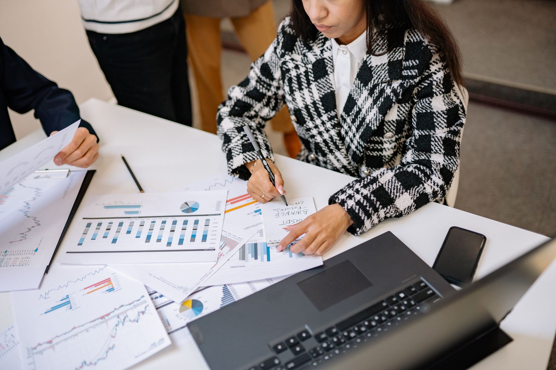 Business professionals reviewing financial documents in a corporate meeting room