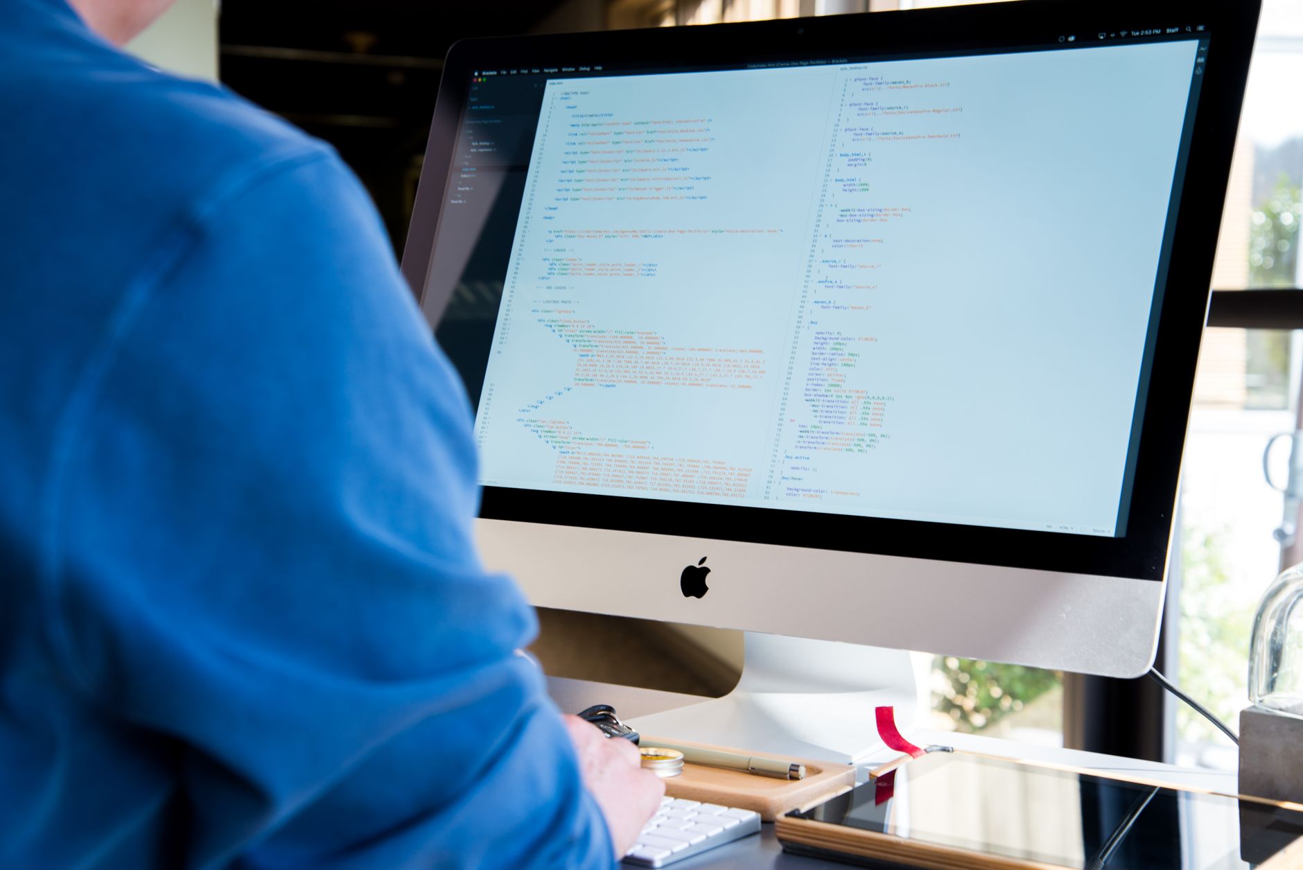 Software developer working on code at a desktop computer