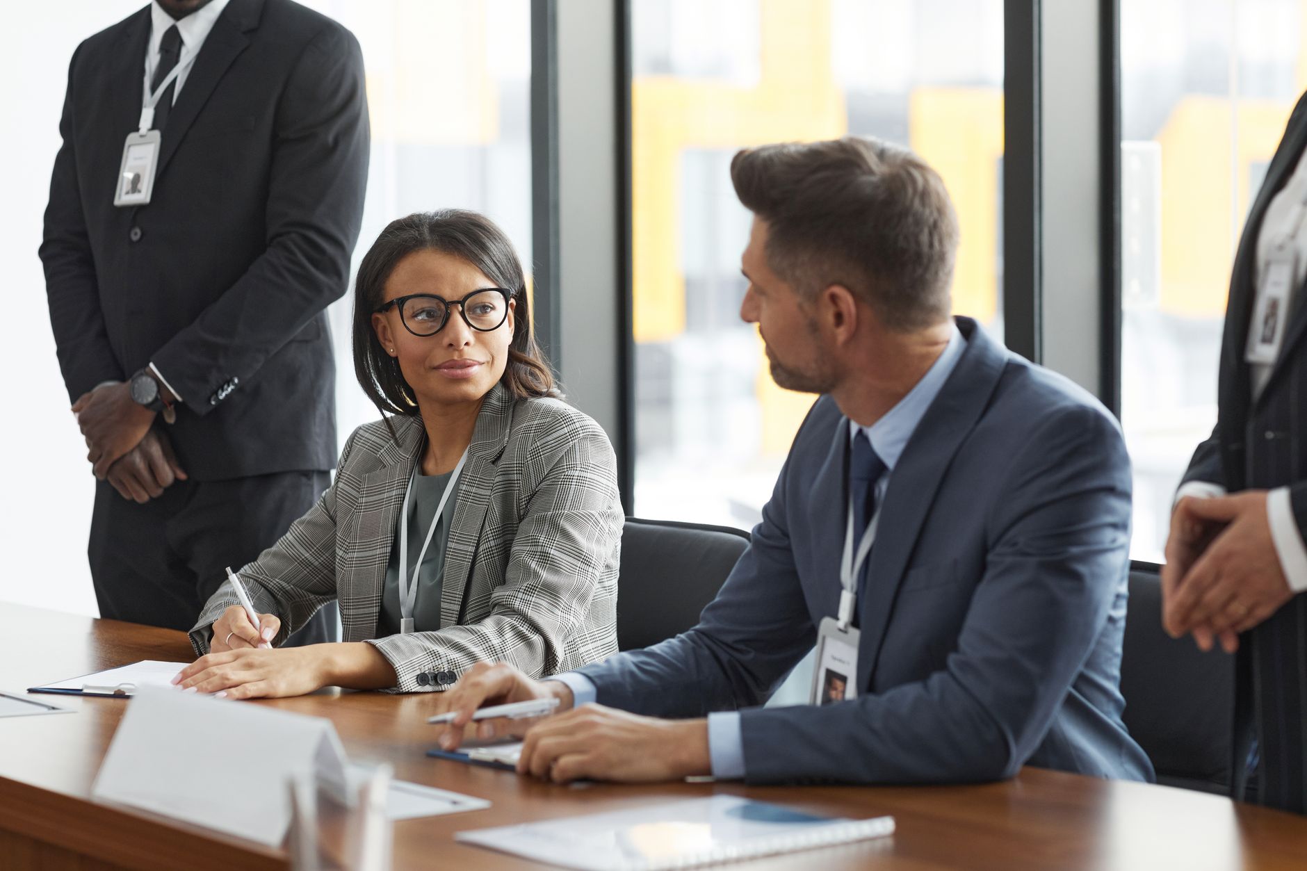 Business professionals reviewing data on laptops during a corporate meeting