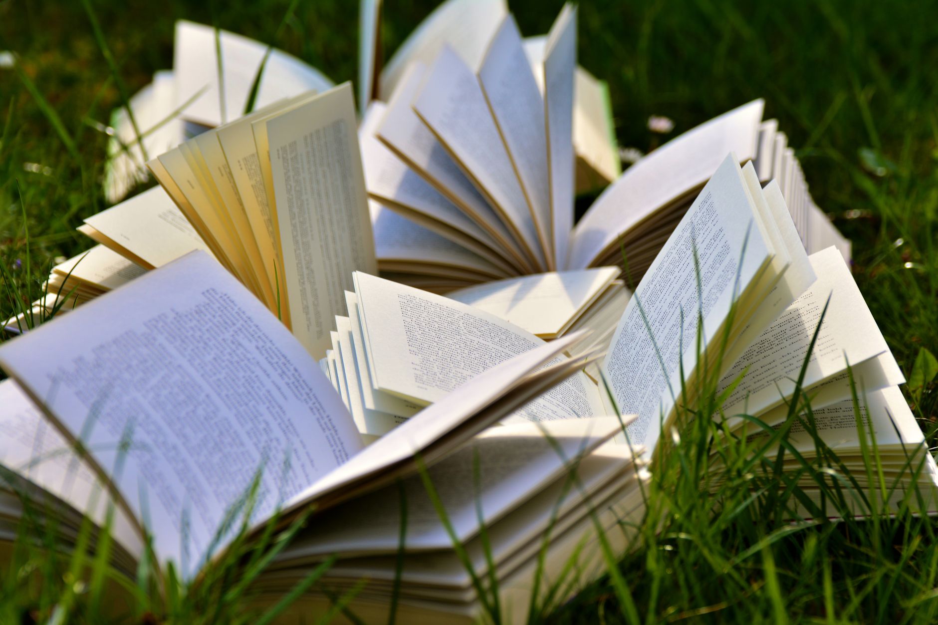 Stack of open books in a library setting representing audiobook publishing