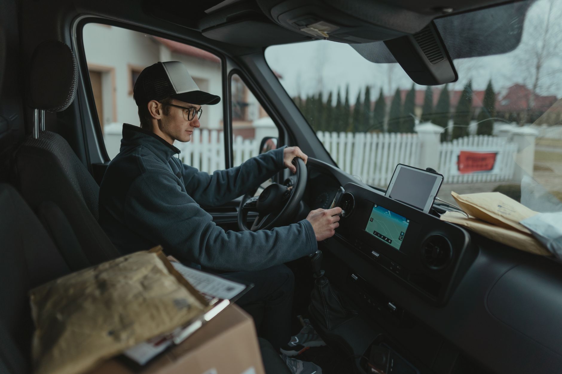 Delivery driver carrying packages on a city street for same-day retail orders