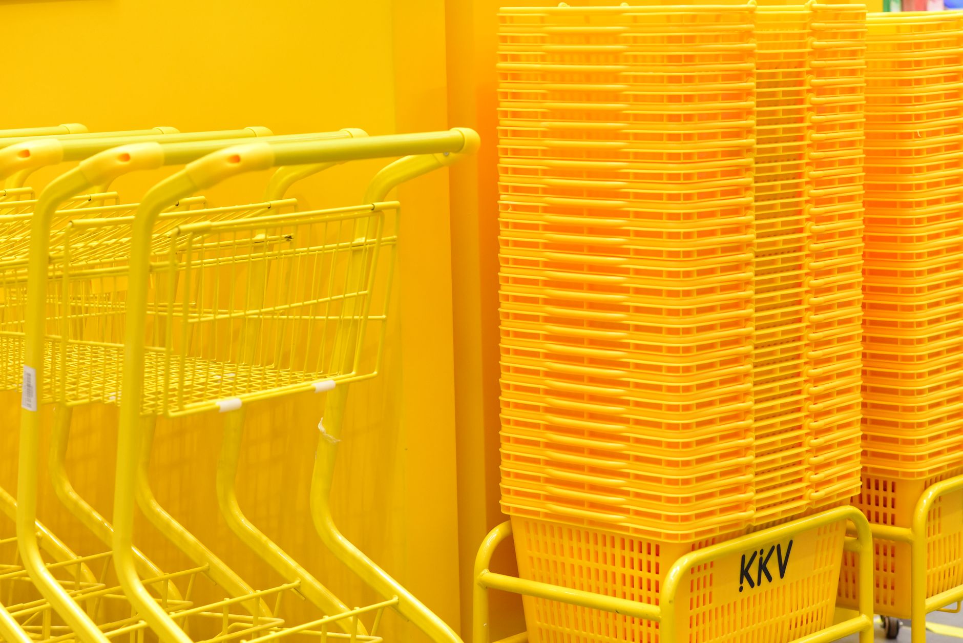 Shopping cart filled with grocery items in a large retail store