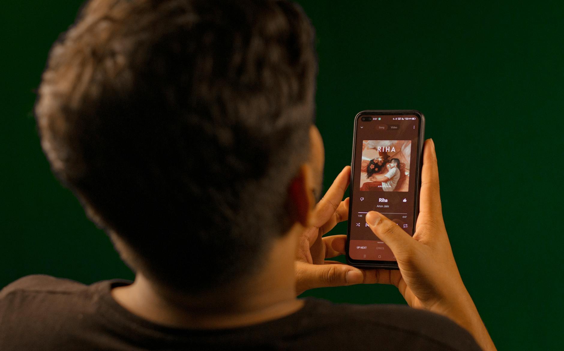 Person using a music streaming app on a smartphone