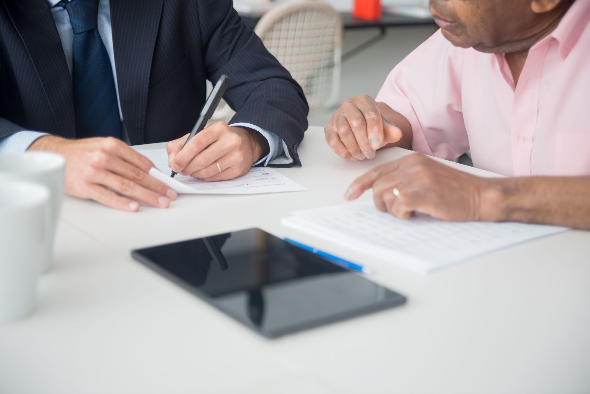 Professional advisor consulting with clients at a conference table