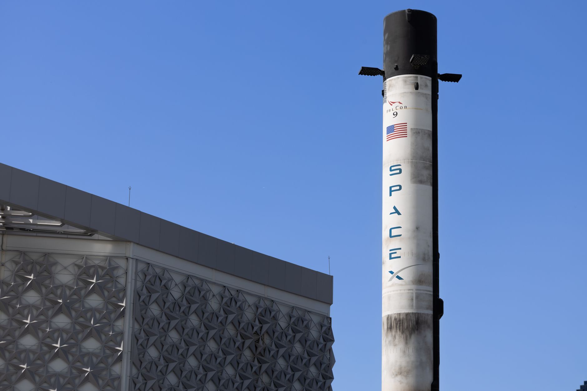 Rocket launching into sky representing satellite deployment for broadband constellations