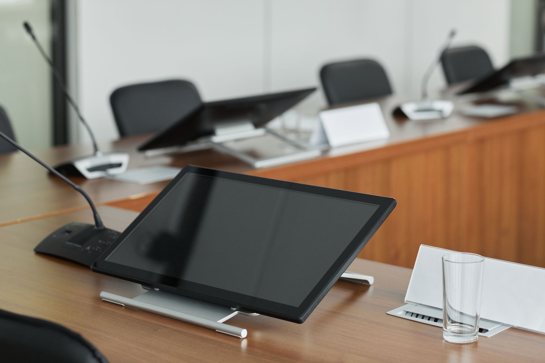 Empty corporate boardroom with chairs around a long table