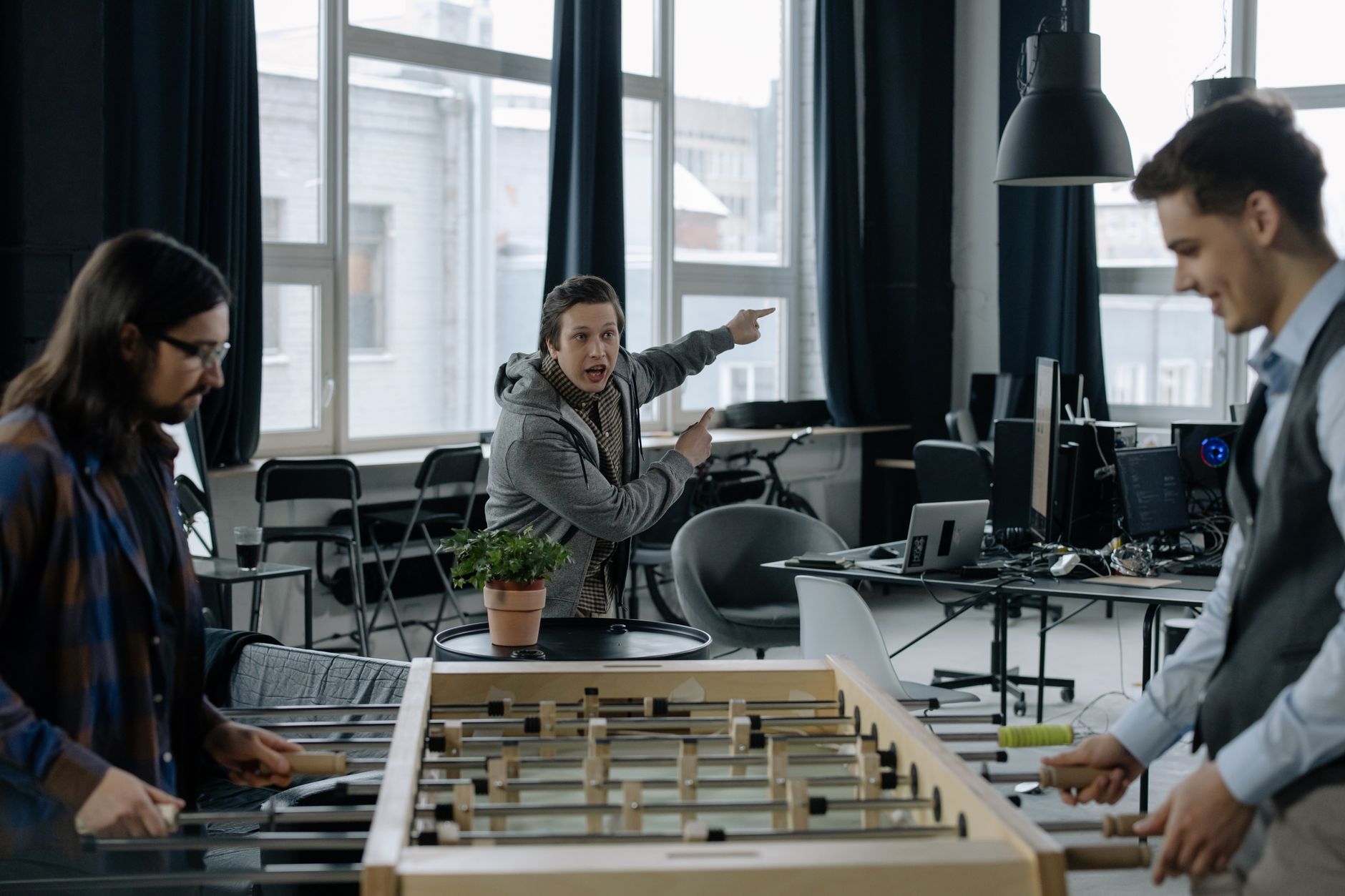 Modern technology company open office workspace with employees at computers