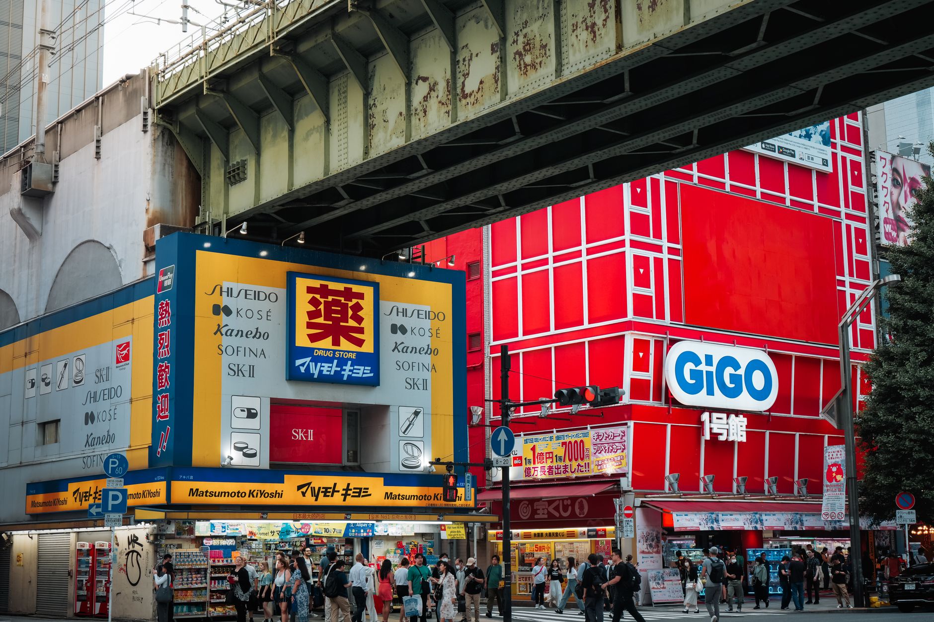 Busy retail street in Tokyo with storefronts and pedestrian traffic