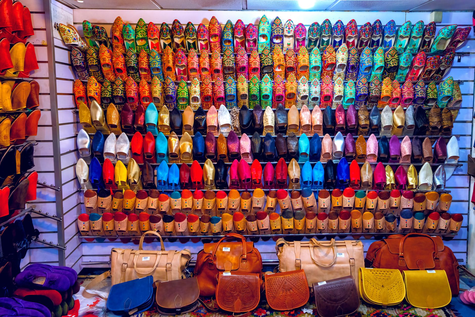 Shoppers browsing sneakers at a footwear store inside a shopping mall