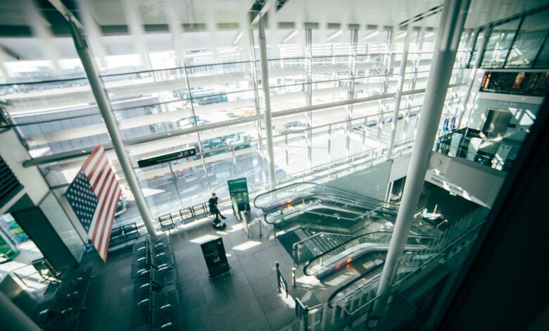 Busy airport terminal with travelers walking through departures hall