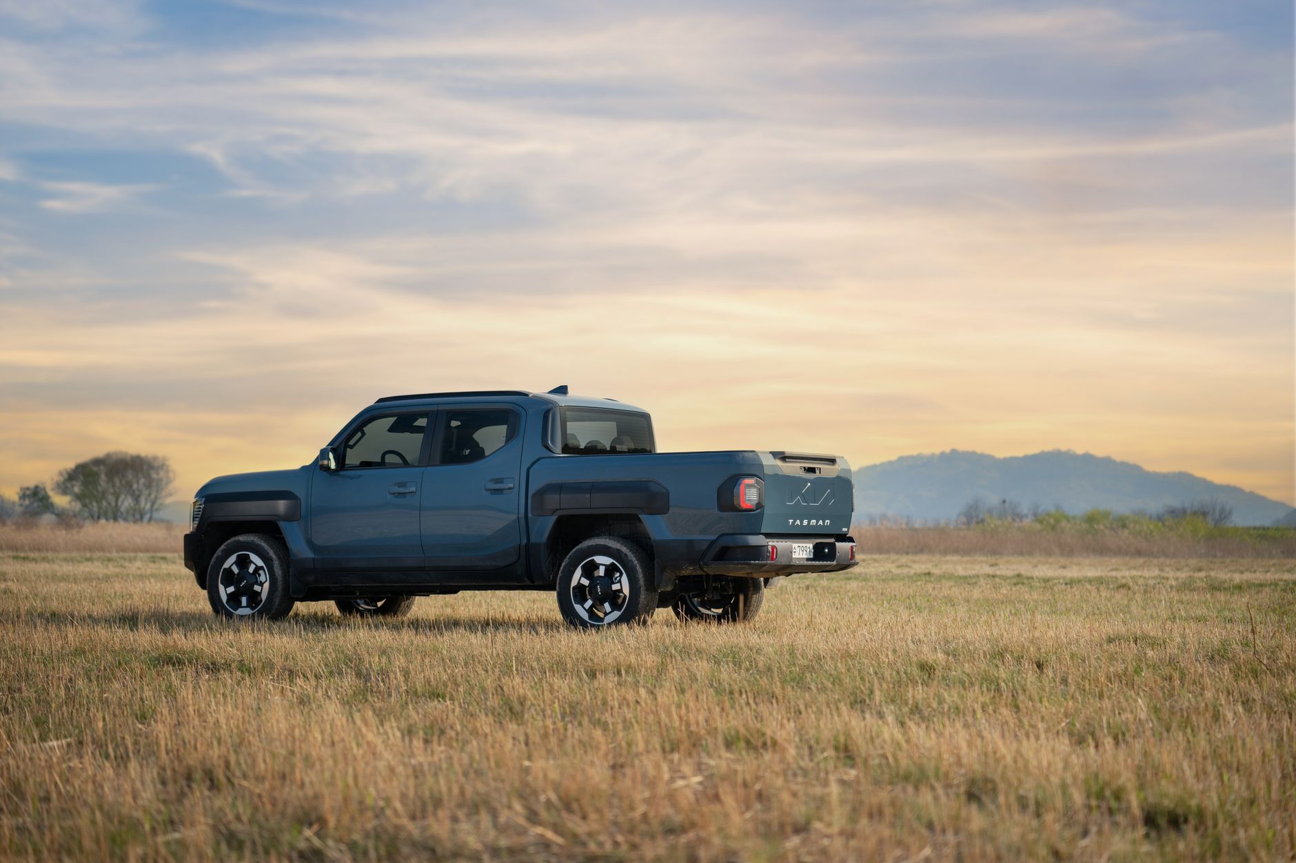Electric pickup truck charging at an outdoor station