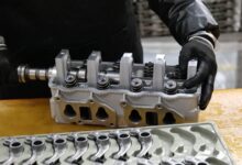 Workers on a modern automotive assembly line producing electric vehicles