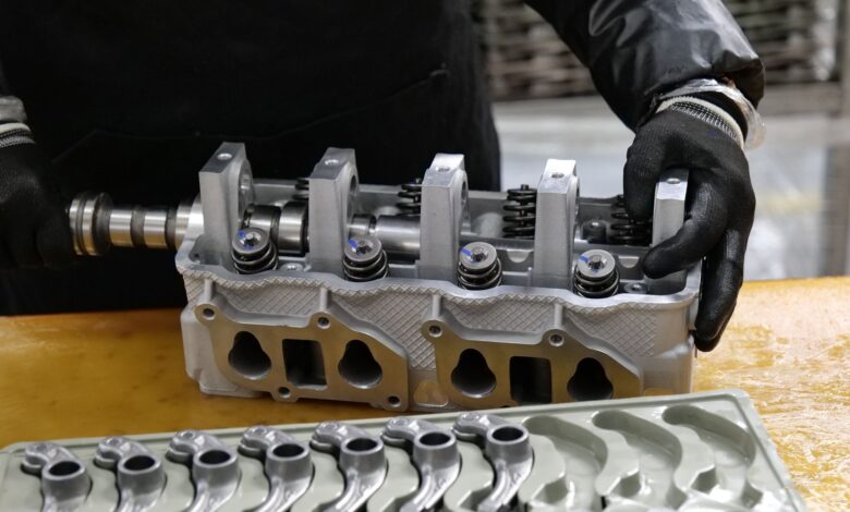 Workers on a modern automotive assembly line producing electric vehicles