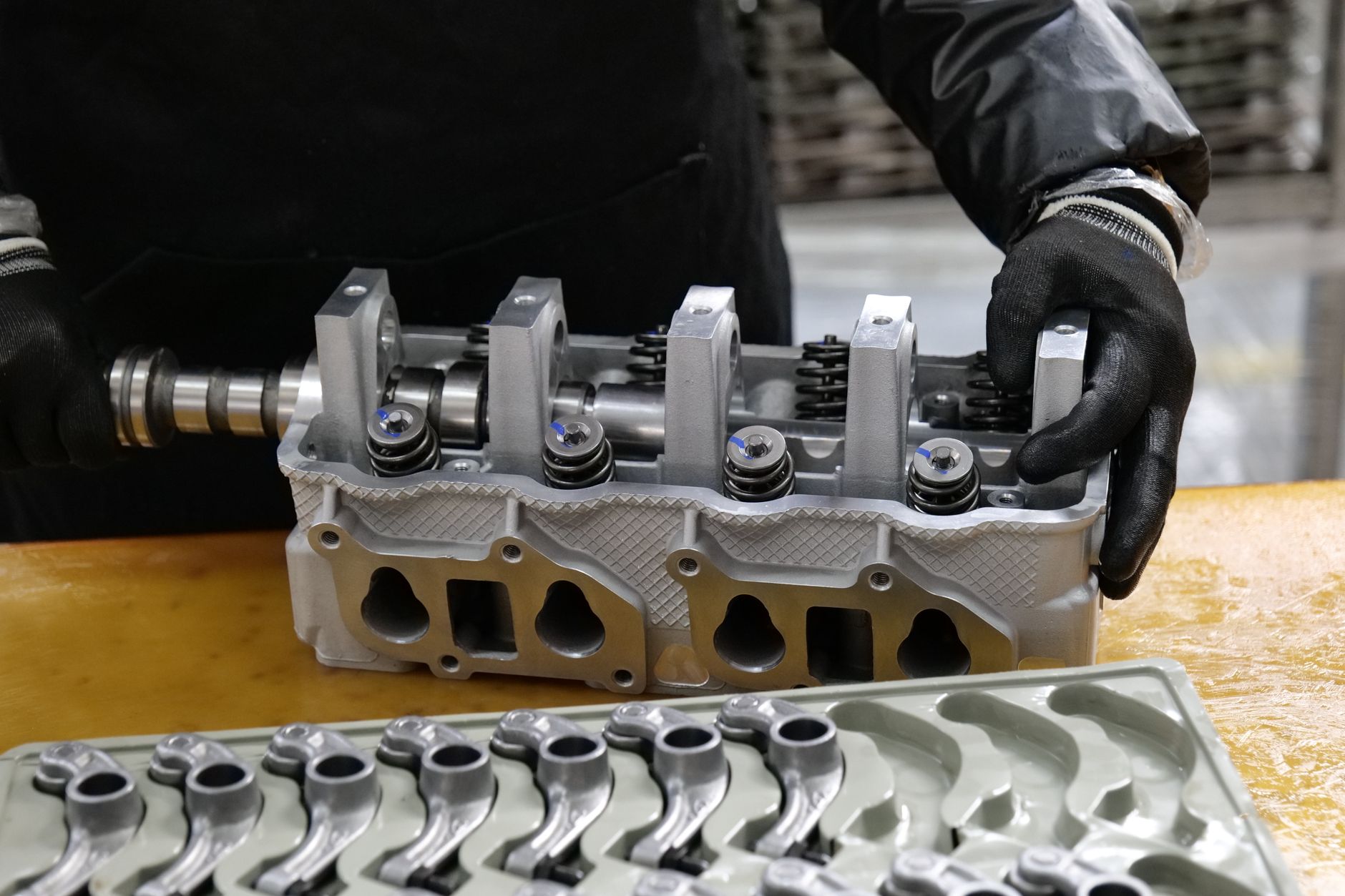 Workers on a modern automotive assembly line producing electric vehicles