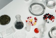 Workers inside a pharmaceutical manufacturing facility reviewing production lines