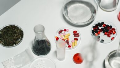 Workers inside a pharmaceutical manufacturing facility reviewing production lines