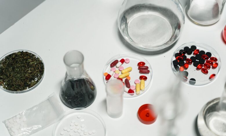 Workers inside a pharmaceutical manufacturing facility reviewing production lines