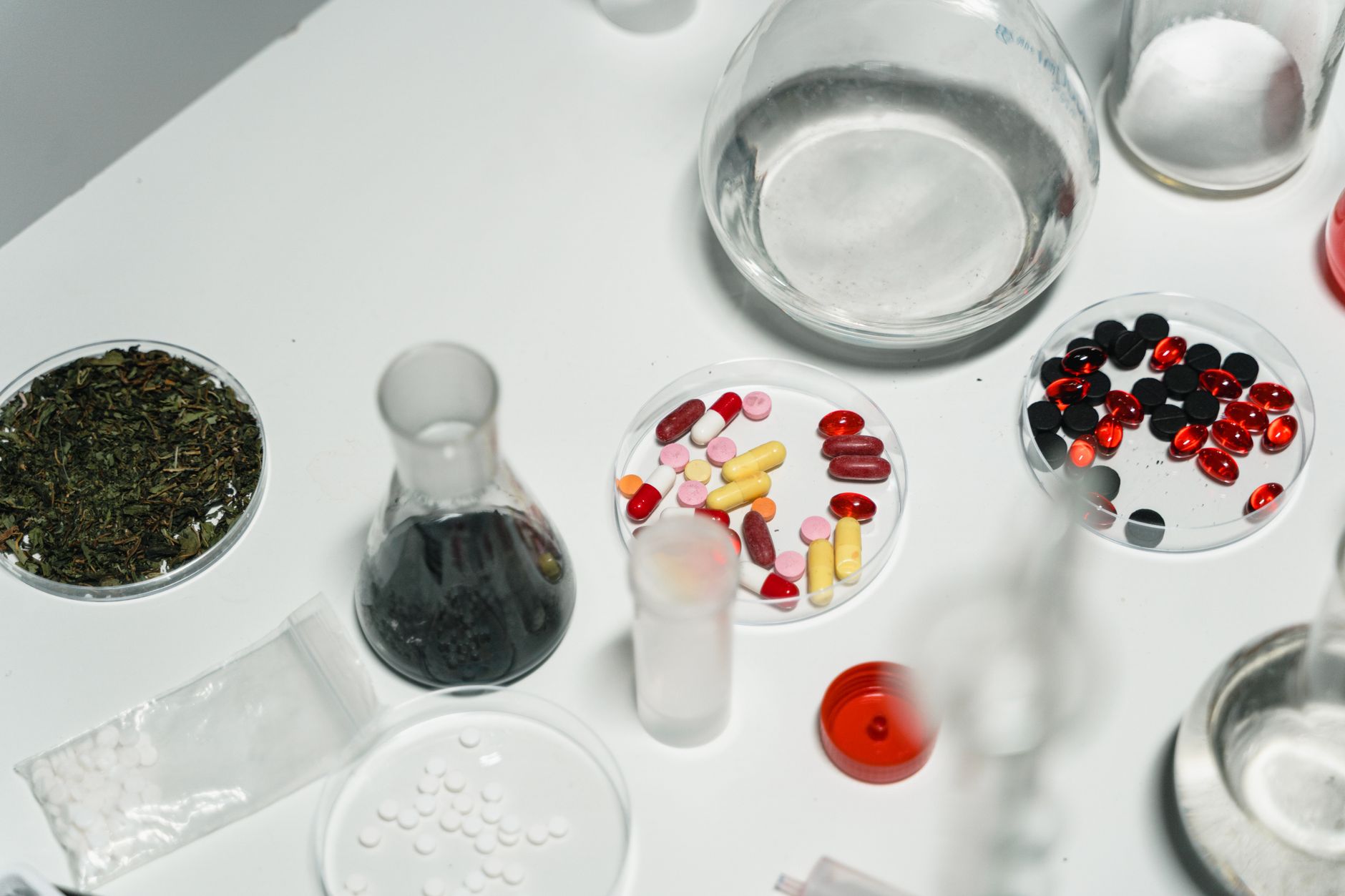 Workers inside a pharmaceutical manufacturing facility reviewing production lines