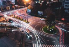 A self-driving vehicle navigating an urban road, representing the robotaxi industry