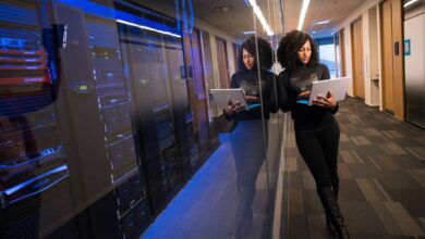 Rows of servers inside a large modern data center facility