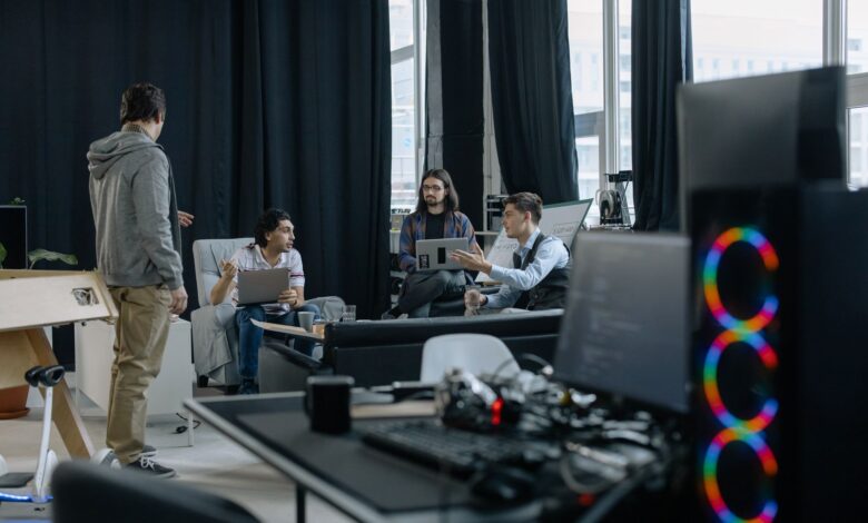 Business professionals reviewing software dashboards in a modern office meeting room