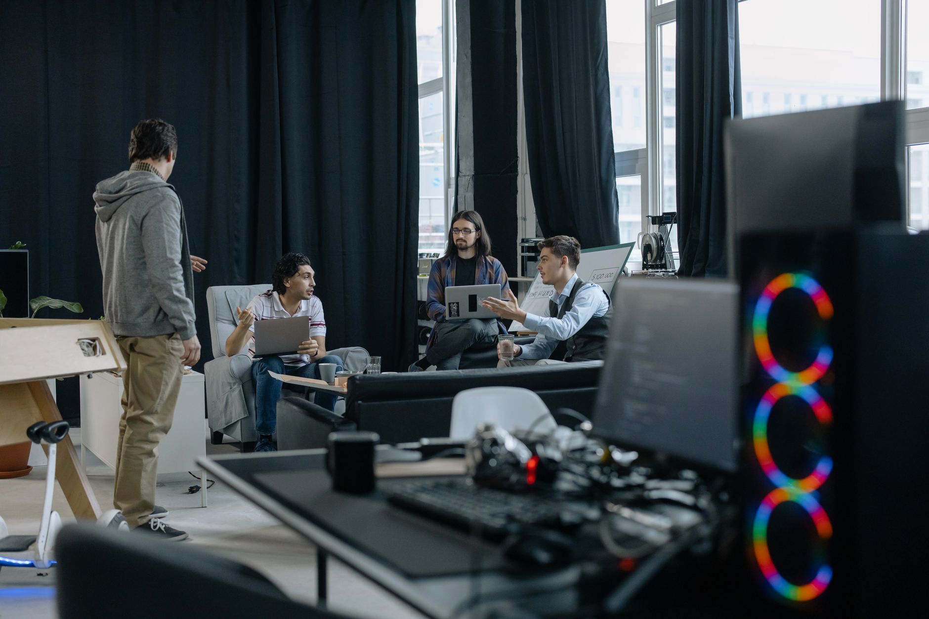 Business professionals reviewing software dashboards in a modern office meeting room