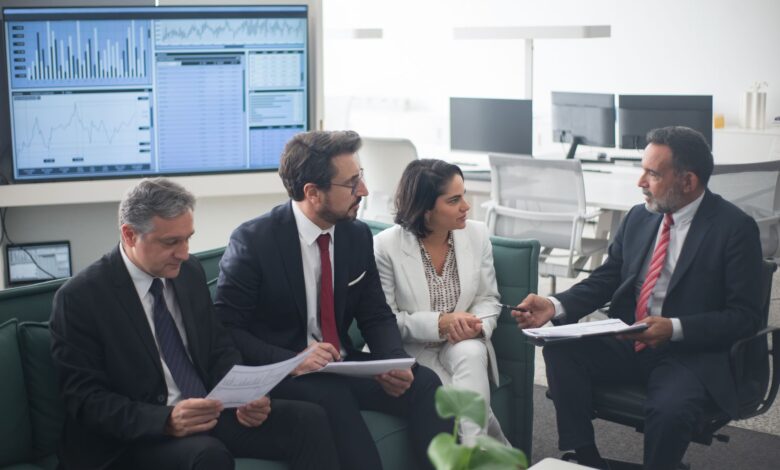 Corporate banking professionals in a formal office meeting discussing client strategy