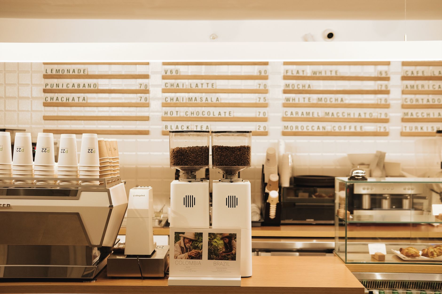 Coffee shop menu board displaying drink options and prices