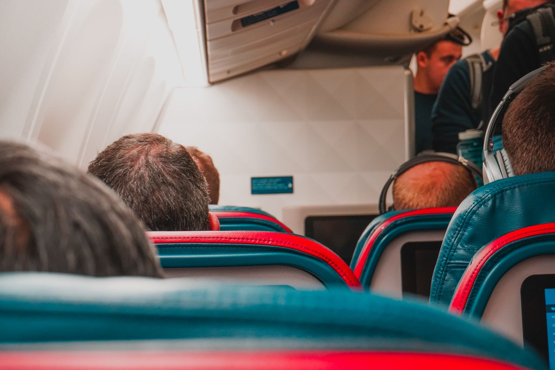 Economy class airplane cabin with rows of passenger seats