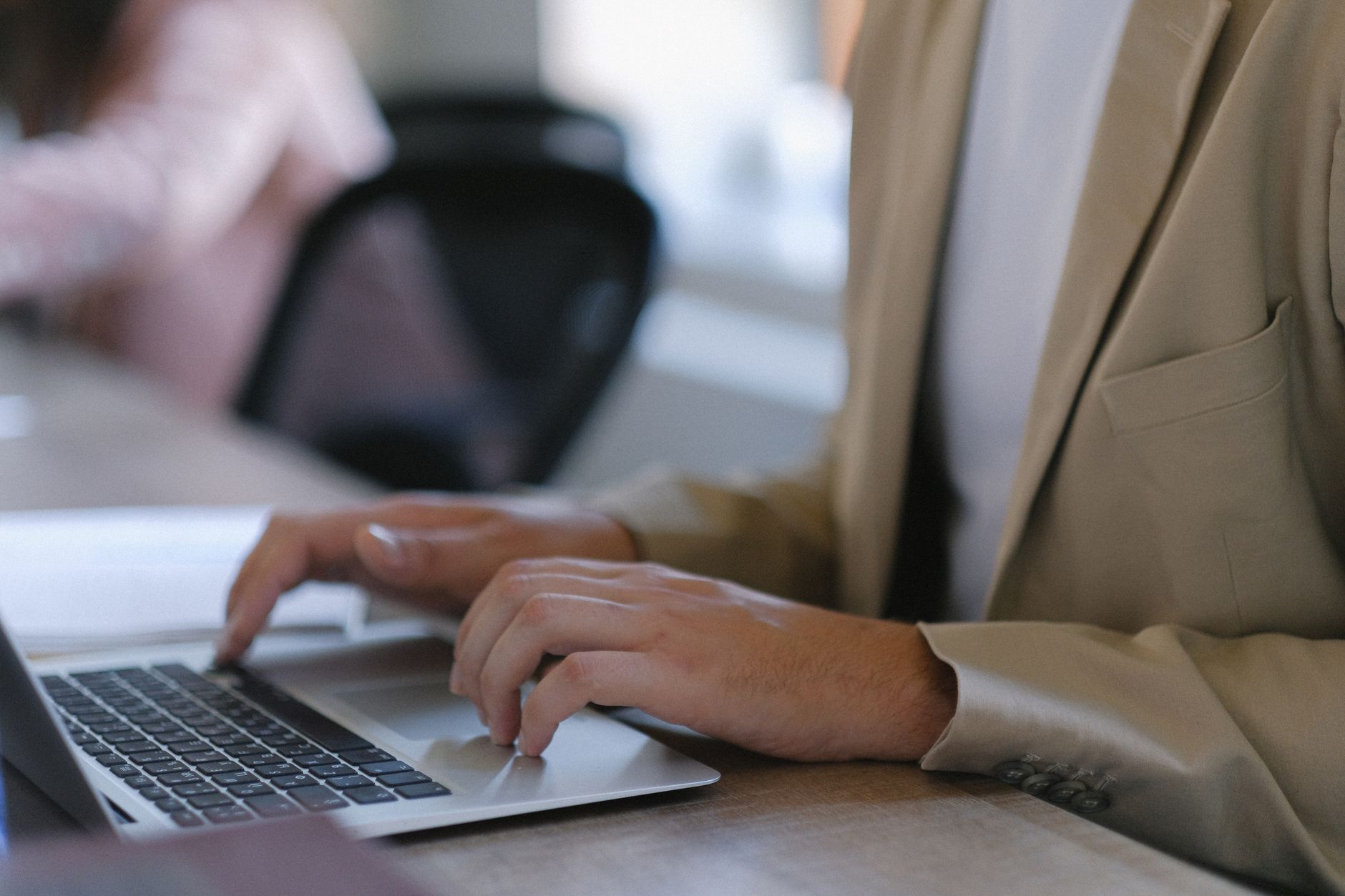 Business professional working on a laptop in a modern office environment
